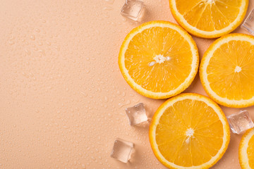 Juicy season summer spa concept. Top above overhead flat lay close up photo of tasty delicious slices of orange fruit and ice cubes with place for text empty blank space