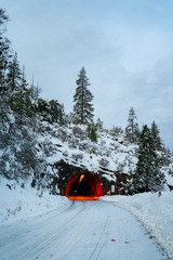 View of snow covered tunnel with red lights