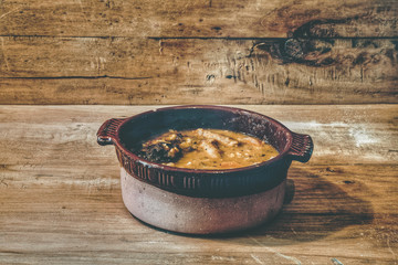 photography traditional food dish lentils with vegetables and blood sausage with chorizo
