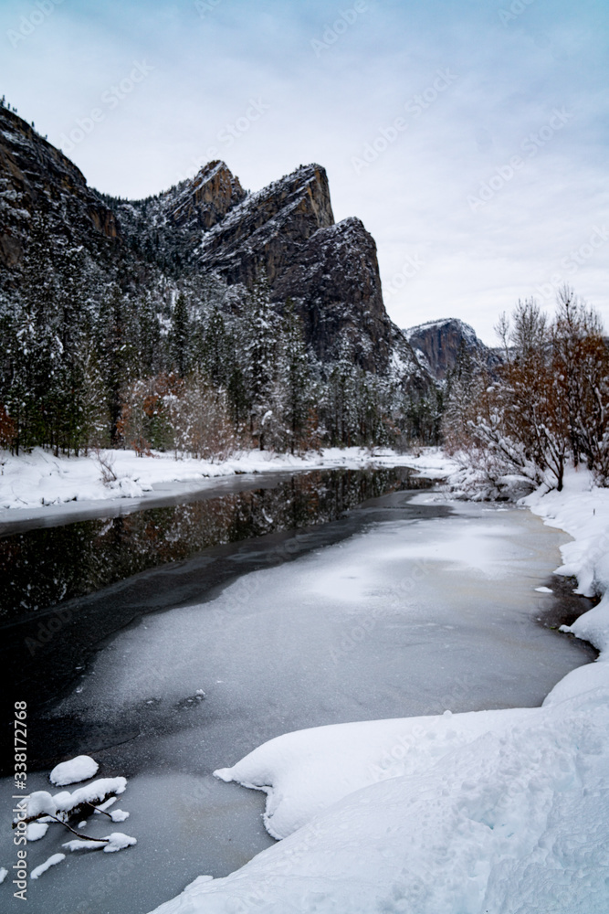 Wall mural view of frozen river and mountains in winter