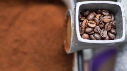 coffee beans in a manual coffee grinder