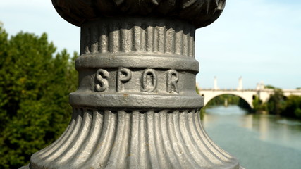 Detail of cast iron lamppost stand on a bridge with SPQR written (from the Latin Senatvs PopvlvsQve...