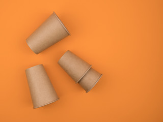 Organic cups on orange background. The view from the top.