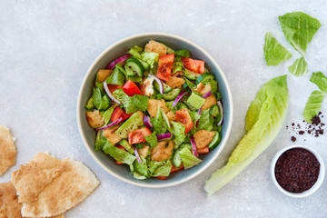 Traditional lebanese bread salad fattoush with ingredients . Top view with copy space              ...
