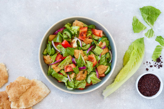 Traditional lebanese bread salad fattoush with ingredients . Top view with copy space                       