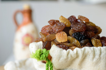 Close up raisins in a canvas bag.