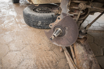 Exposed or stripped wheel axle of a car, the place where usually hub with bearings sit and turn. Anchor point for a hub of a car wheel. - obrazy, fototapety, plakaty