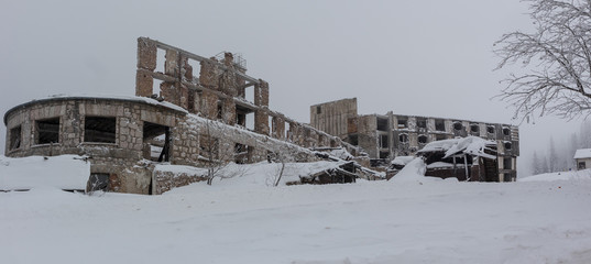 Remains of an old hotel destroyed in bosnian war in the nineties on the hill of Jahorina in cold...
