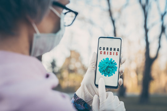 Senior Woman Using Coronavirus Tracking App On Her Phone