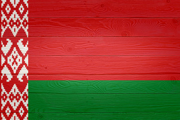 Belarus flag painted on old wood plank background. Brushed natural light knotted wooden board texture. Wooden texture background flag of Belarus.