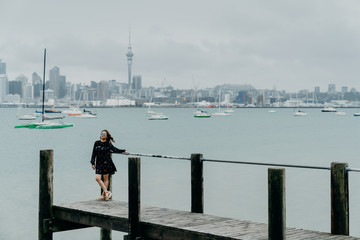 9/3/2020 Auckland city with sky tower and beautiful traveller. The famous landmark in North island, Auckland, New Zealand.