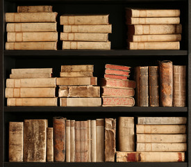 antique books on old wooden shelf.