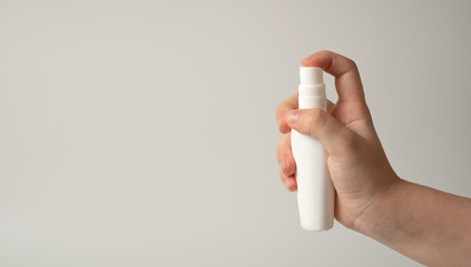 Hands of the child with a disinfectant solution to protect against viruses, bacteria. The concept of protecting and preventing the spread of the virus.