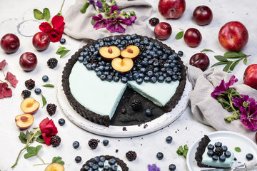 fresh blueberry tart with fruits on white conrete background