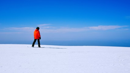 Snowboarder on the snow in the mountains. Back / side view