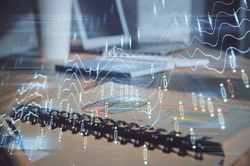 Double exposure of financial graph drawings and desk with open notebook background. Concept of forex market