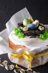 Easter, Easter cake on a dark background, decorated chocolate nest with eggs and a bird of chocolate, beautiful scenery, soft focus