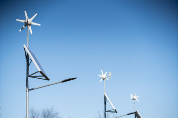 Solar batteries with a wind turbine to power led lamps.