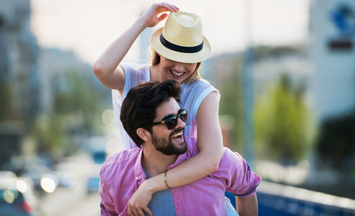 Happy loving couple. Boyfriend carrying his girlfriend on piggyback. Love, dating, romance