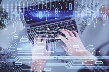 Double exposure of man's hands typing over computer keyboard and data theme hologram drawing. Top view. Technology concept.