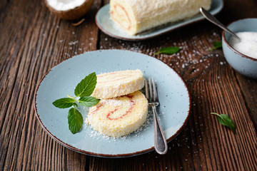 Delicious dessert, coconut roulade slices filled with vanilla and rum buttercream