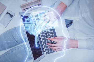 Double exposure of woman working on computer andhuman brain hologram drawing. Top View. Ai concept.