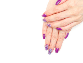female fingers with painted nails. lilac nails with a pattern.