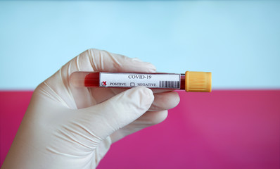 COVID-19 Pandemic Coronavirus concept ; Close-up of a Positive COVID-19 blood test sample tube with Flag of Poland at background. Blood testing for diagnosis new Corona virus infection.