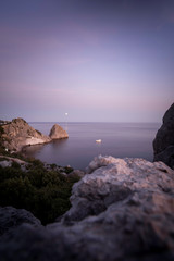Moon road to the sea. The ship sails on the sea. Night landscape.