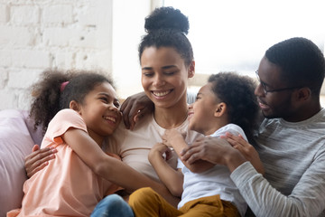African american happy family with two kids enjoy time together. Cute diverse daughter and son with...