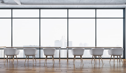 Office room with chairs and panoramic city view.