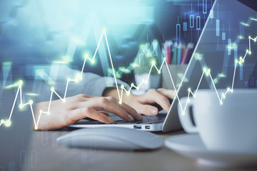 Double exposure of woman hands typing on computer and forex chart hologram drawing. Stock market invest concept.