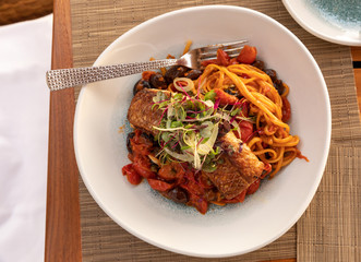 A plate of pasta and salmon at a restaurant