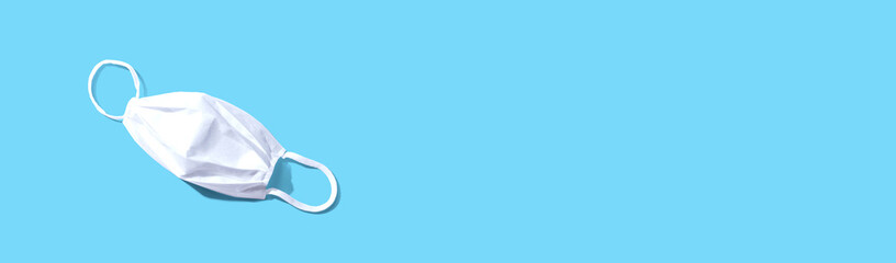 White surgical mask overhead view - flat lay