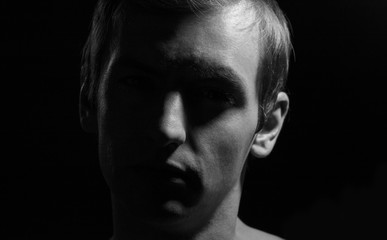 Fototapeta na wymiar black and white dramatic portrait of a guy