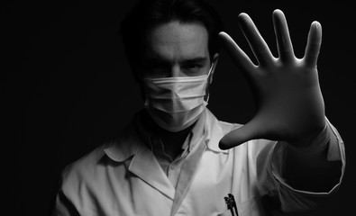 Virus mask male doctor wearing face protection in prevention for coronavirus showing gesture Stop...