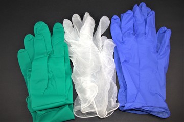 Medical gloves in different colors isolated in white background. Personal Protective Equipment or PPE  use in medical health care.