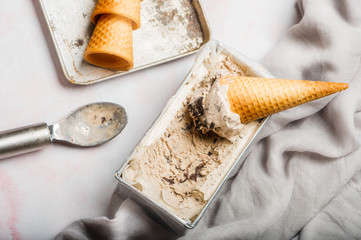 Homemade Cookies and Cream Ice Cream in Cone Flat lay with gray cloth accent 