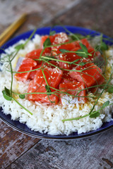 Selective focus. Macro. Poke bowl with salmon and microgreens. Healthly food.