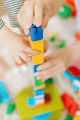 Mom and daughter collect color plastic constructor