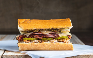 Hot melted ham pickle and cheese sandwich with steam