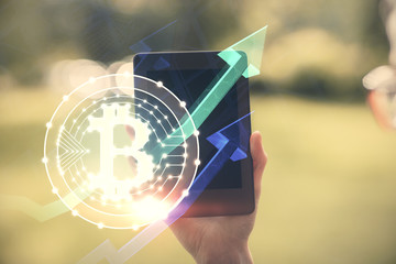 Double exposure of blockchain business sketch hologram and woman holding and using a mobile device.