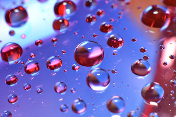 shiny clear water point attached to a glass reflects the same color as the color on the glass into a beautiful background as decoration