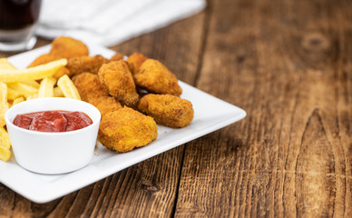 Vintage wooden table with fresh made Chicken Nuggets