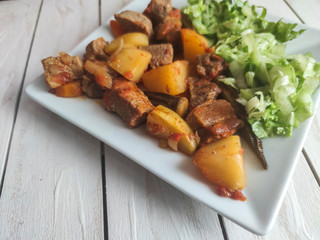 Gyuvech-traditional Balkan food with meat, potatoes and vegetables