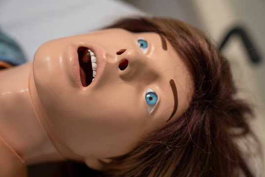 Close Up Of The Face Of A White Female Manikin Patient In Distress In The Hospital.