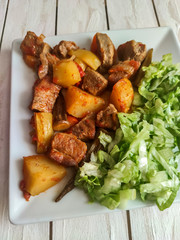 Gyuvech-traditional Balkan food with meat, potatoes and vegetables