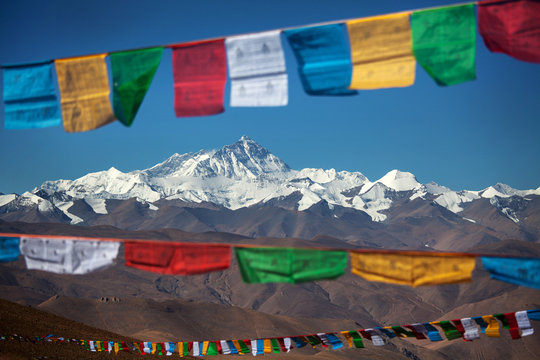 Prayer Flags Hanging Against Mountain And Sky