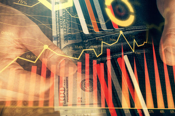 Multi exposure of forex graph drawing hologram and USA dollars bills and man hands. Technical...