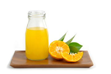 Naklejka na ściany i meble Fresh orange juice above wood coaster, with raw, sliced orange fruit – isolated on white background